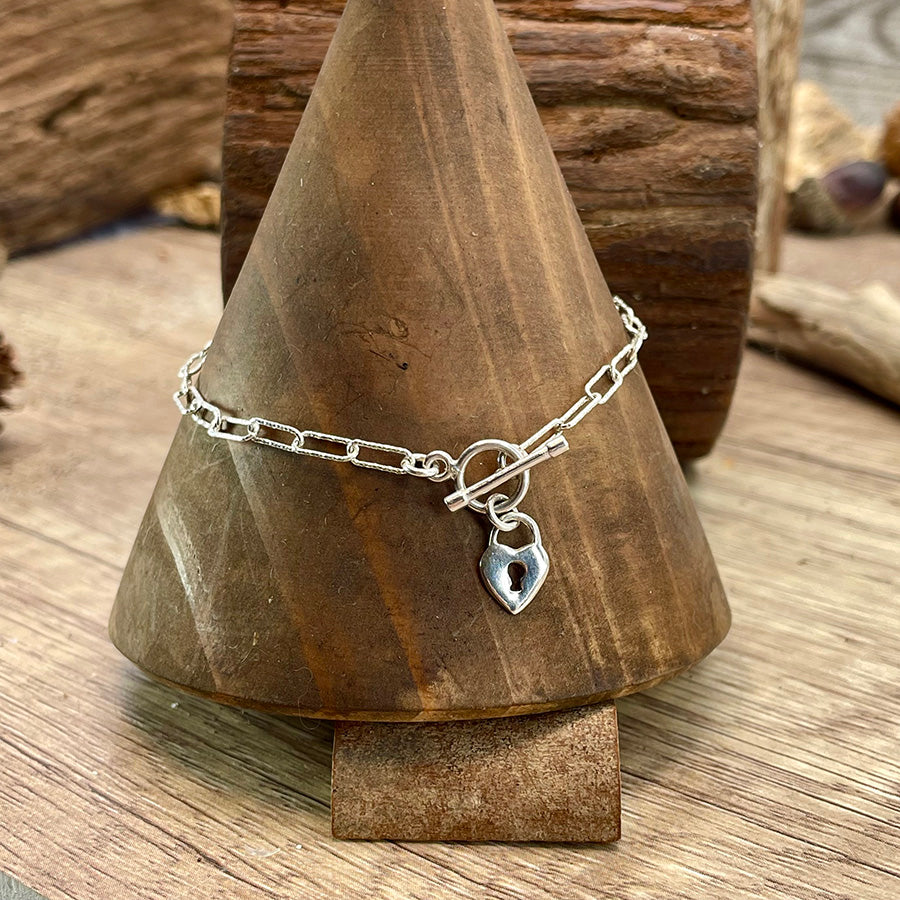 Bracelet femme KEYS ? NOT INCLUDED – chaîne à maillons rectangulaires facettés, fermoir toggle et pendentif cadenas cœur en argent 925