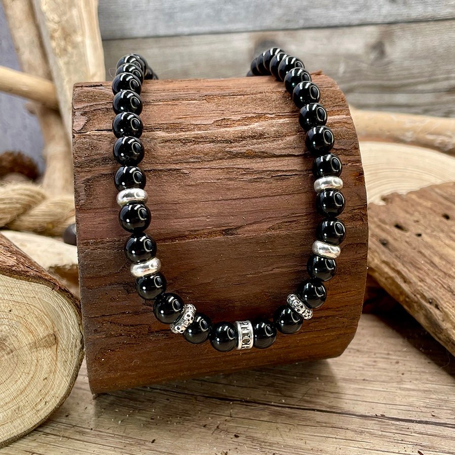 Collier homme BAD OMEN – perles d’onyx, donut logo gravé, skulls tête de mort et argent 925 – bijoux fait main en argent 925 | Pitch & Néo